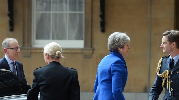 Prime Minister Theresa May with her husband Philip arrives at Buckingham Palace to seek the Queen's permission to form a UK government. 