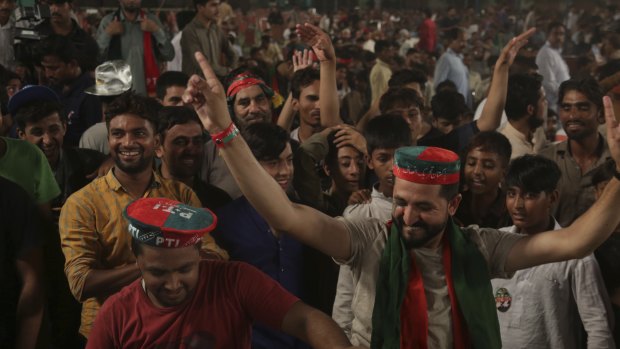 Supporters of Pakistani politician Imran Khan, chief of Pakistan Tehreek-e-Insaf party, celebrate during an election campaign in Lahore, Pakistan.