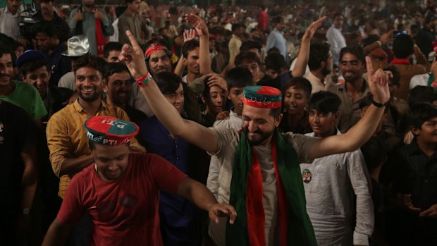 Supporters of Pakistani politician Imran Khan, chief of Pakistan Tehreek-e-Insaf party, celebrate during an election campaign in Lahore, Pakistan.