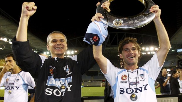 Hard road: Vitezslav Lavicka and Karol Kisel of Sydney hold the trophy after the 2010 A-League grand final win over Melbourne.