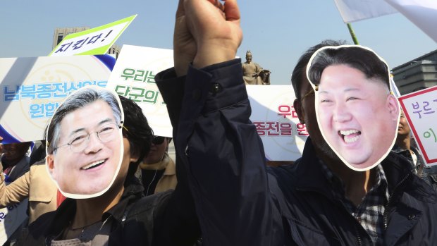 South Korean activists wearing masks of South Korean President Moon Jae-in, left, and North Korean leader Kim Jong-un welcome the planned summit between the leaders.
