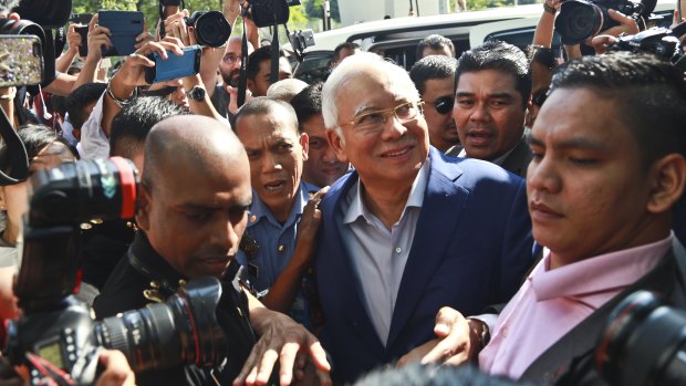 Summoned: former Malaysian PM Najib Razak, centre, arrives at Malaysian Anti-Corruption Commission (MACC) in Putrajaya, Malaysia.