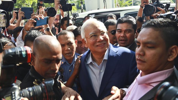 Summoned: former Malaysian PM Najib Razak, centre, arrives at Malaysian Anti-Corruption Commission (MACC) in Putrajaya, Malaysia.