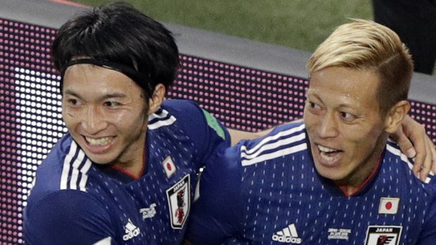 Looking sharp: Keisuke Honda, right, celebrates with teammate Gaku Shibasaki after scoring.