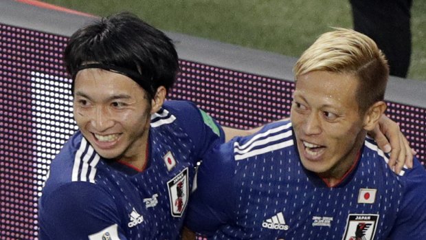 Looking sharp: Keisuke Honda, right, celebrates with teammate Gaku Shibasaki after scoring.