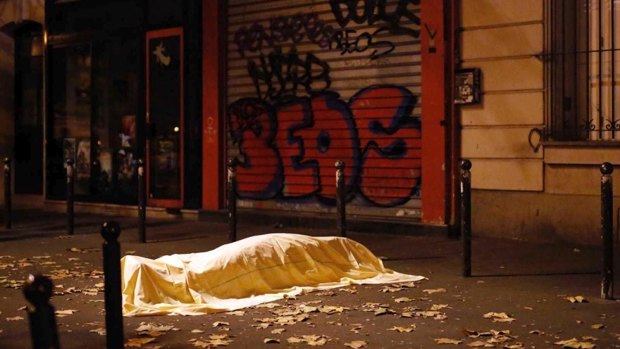 A victim under a blanket lays dead outside the Bataclan theatre in Paris in November 2015.