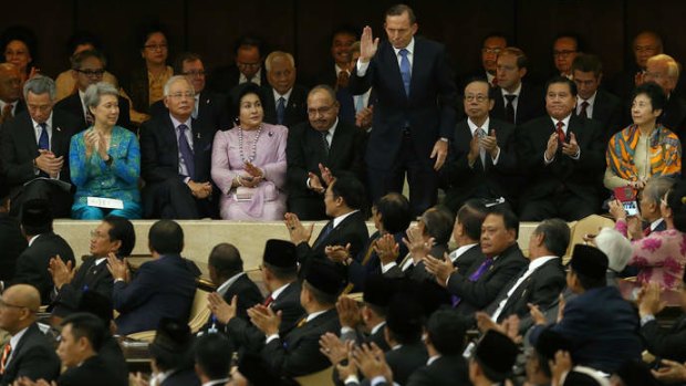 Prime Minister Tony Abbott waves after being acknowledged during the inauguration ceremony of Indonesian President Joko Widodo in Jakarta on Monday.
