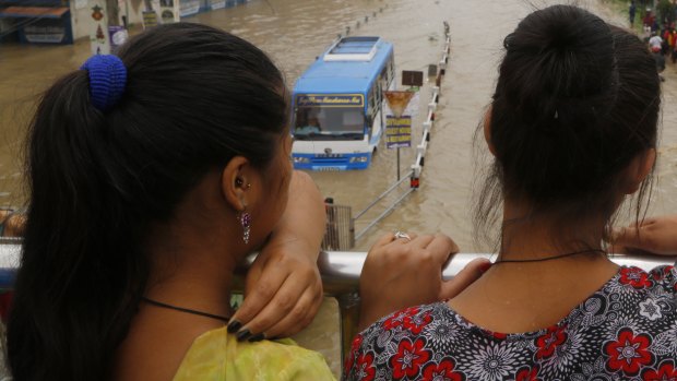 Nepalese women look at a flood area in Bhaktapur.