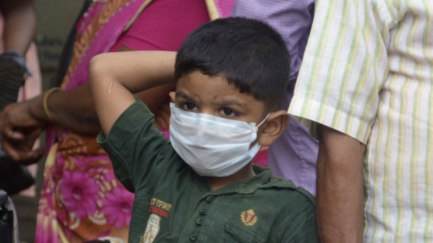 An Indian boy wears a mask as a precautionary measure against the Nipah virus.