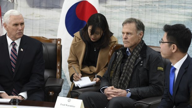 US. Vice President Mike Pence, left, talks with North Korean defector Ji Seong-ho, right, as Fred Warmbier, the father of Otto Warmbier, an American who died after being held in North Korea, listens at the Cheonan Memorial in Pyeongtaek, South Korea in February.