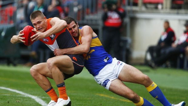 Bird of prey: West Coast's Jack Darling takes down Giant Adam Tomlinson in a dominant all-round performance. 