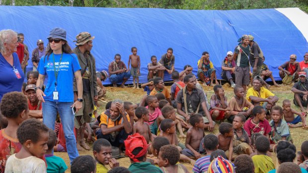 Oil Search's Stephanie Cous-Capmbell, standing second left, said women were at risk of violence within affected communities. 