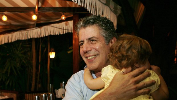 Anthony Bourdain holds his daughter Ariane in Miami Beach in 2008.