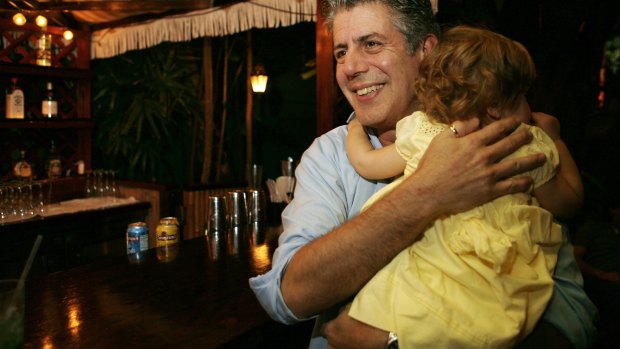 Anthony Bourdain holds his daughter Ariane in Miami Beach in 2008.