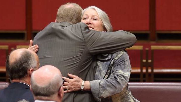 Senator Sue Boyce is hugged by Senator Ian Macdonald after she gave her valedictory speech. Photo: Andrew Meares