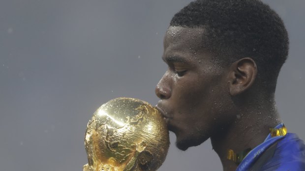 Star man: Paul Pogba kisses the World Cup.