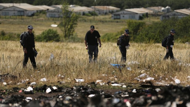 Australian Federal Police and their dutch counterparts search the MH17 crash site in Ukraine for human remains in 2014.