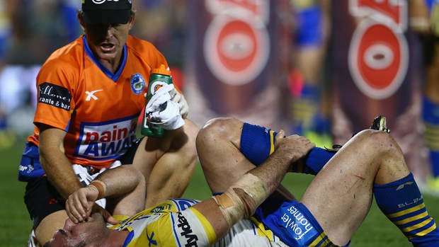 Eels trainer Trent Elkin with Tim Mannah as he holds his injured leg.