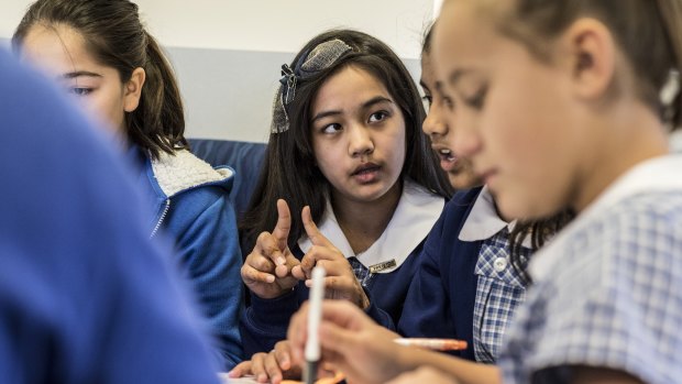 Sana Rezae, 11, sits with other year six students from Merrylands East Primary School, where they work together in groups. 