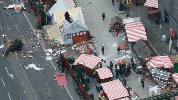 German Chancellor Angela Merkel and other government members visit the site of the attack in Berlin.