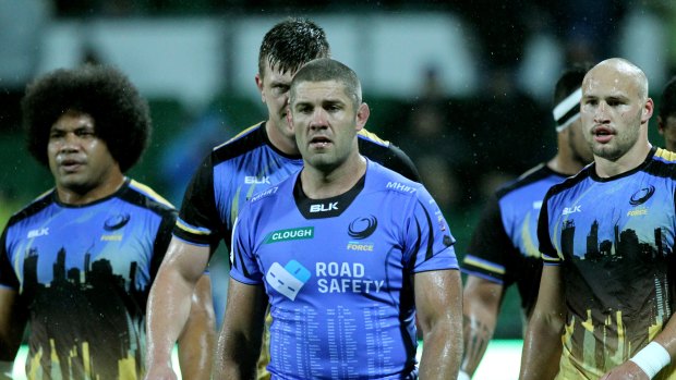 Dark days: Matt Hodgson, centre, and team mates after the Western Force's last Super Rugby game.
