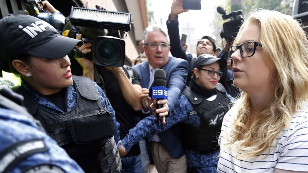 Cassandra "Cassie" Sainsbury,is escorted by police to a court hearing in Bogota, Colombia.