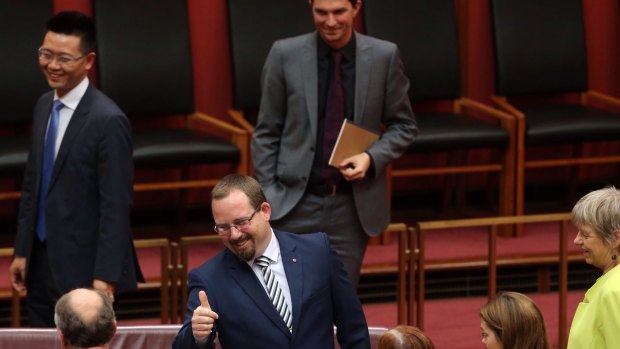 Senator Ricky Muir gives the thumbs up to Senate Leader Eric Abetz after he made his first speech to the Senate in Canberra on Thursday.