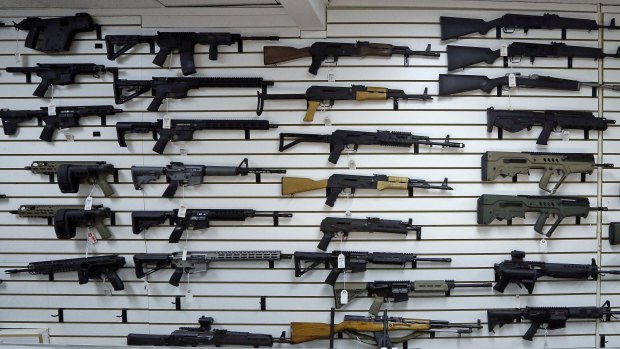 Dozens of semi-automatic rifles on a wall in a gun shop in Lynnwood, Washington..