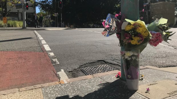Flowers have been laid at the intersection between Ann and Wharf streets where a woman died after she was hit by a bus on Tuesday.
