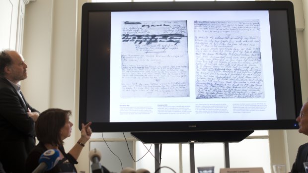 A video shows the text underneath two taped off pages from Anne Frank's diary.