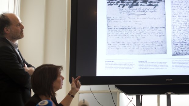 A video shows the text underneath two taped off pages from Anne Frank's diary.