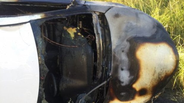 Two police officers smashed the windscreen and pulled the man from his burning car in Gympie on Wednesday.