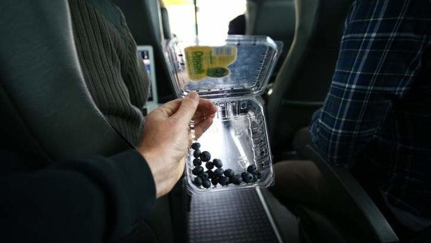 Prime Minister Kevin Rudd gives blueberries to the  media in Sydney on Friday.