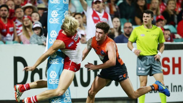 Isaac Heeney crashes into the goal post at the SCG.