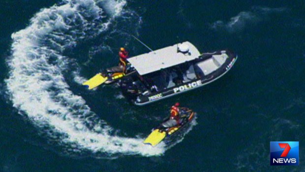 Rescue crews search the seas off South Stradbroke Island after a Tiger Moth crashed.