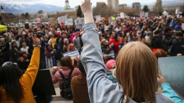 Sage Dennison, 15, a student at Stansbury High School in Tooele, flashes a peace sign during the "March for Our Lives" at the Capitol in Salt Lake City on Saturday.