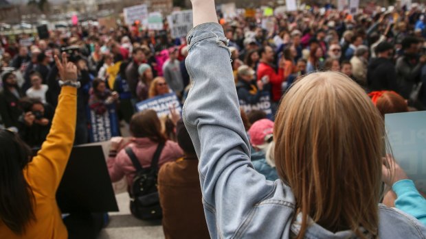 Sage Dennison, 15, a student at Stansbury High School in Tooele, flashes a peace sign during the "March for Our Lives" at the Capitol in Salt Lake City on Saturday.