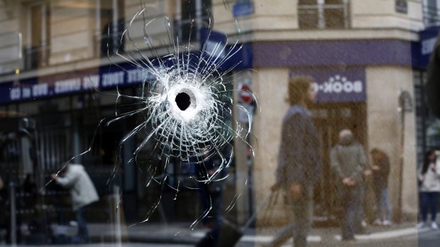 A bullet hole seen on the window of a cafe located near the area where the assailant of a knife attack was shot dead by police officers, in central Paris on Sunday.