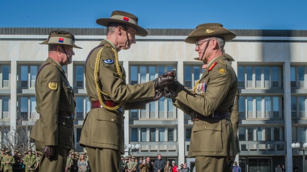 Lieutenant General Angus Campbell hands over command of the Australian Army to Lieutenant General Rick Burr during a ceremony in Canberra.