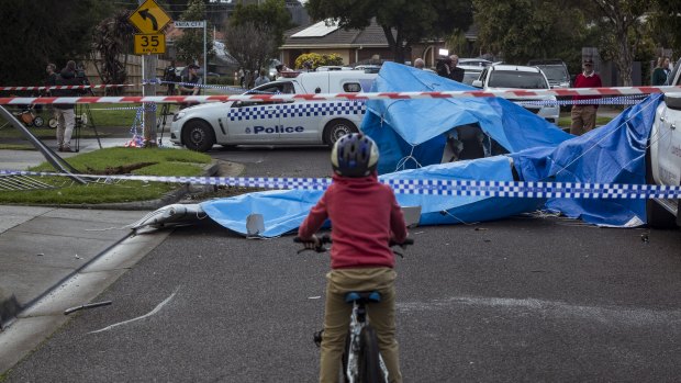 A boy on a bike looks at the wreckage on Saturday morning after the fatal light plane crash Scarlet Street, Mordialloc, on Friday night.