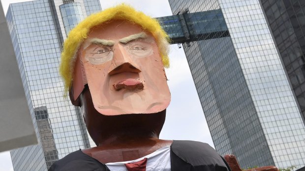 People march with a giant puppet of U.S. President Donald Trump during a demonstration in Brussels,