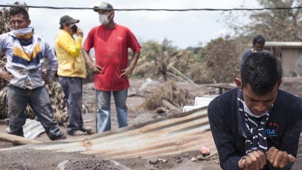 Bryan Rivera cries after looking at the remains of his house in San Miguel Los Lotes, after his family went missing after the eruption.