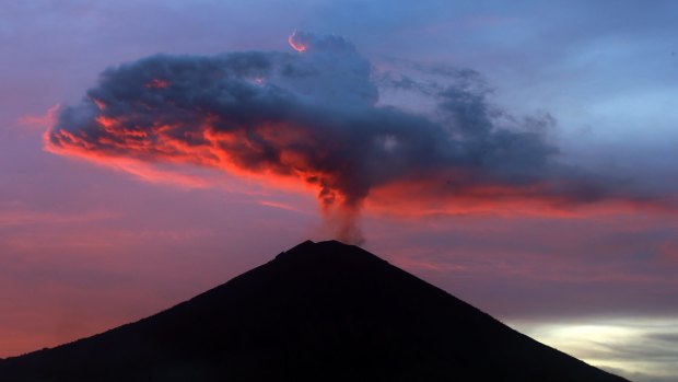 Clouds of ash from the Mount Agung volcano are lit with warm sunset light in Karangasem, Bali last year.