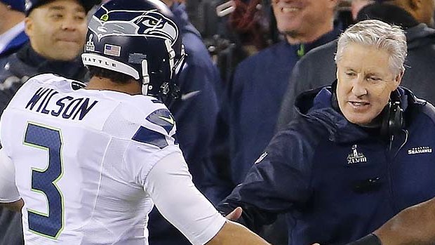 Coach Pete Carroll goes to congratulate Russell Wilson.