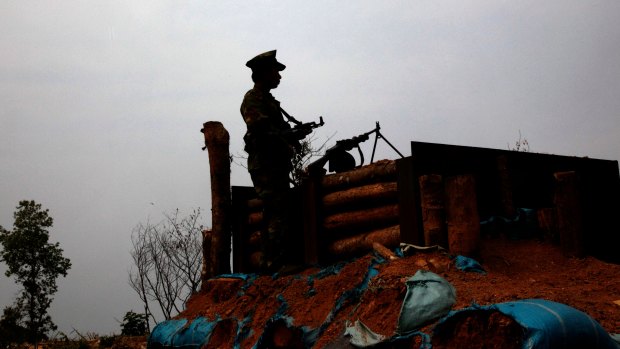 Kachin Independence Army rebel watches no man's land, towards the Myanmar army front line from a outpost in Hpalap mountain last month. 