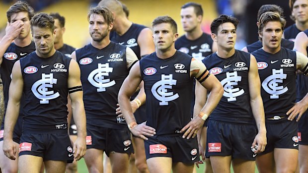 Marc Murphy leads his team from the field after the loss to Gold Coast.