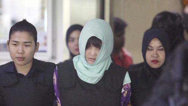 Vietnamese Doan Thi Huong, centre, is escorted by police as she leaves court after a hearing at Shah Alam High Court in Malaysia on Thursday.