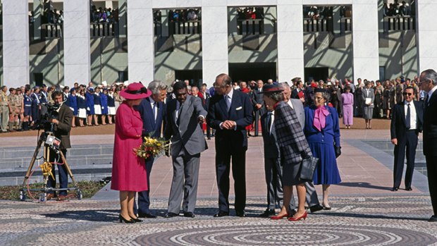 Queen Elizabeth II, Prime Minister Bob Hawke, artist Michael Nelson Jagamara and the Duke of Edinburgh at the official opening of new Parliament House, Canberra, 1988. 