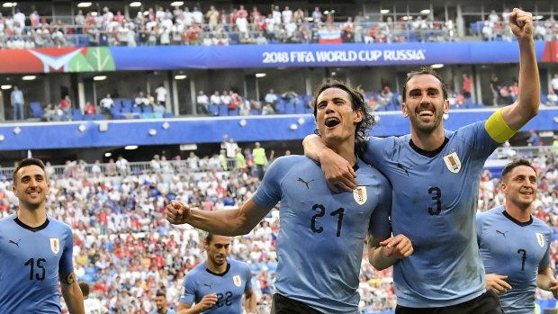 Uruguay's Edinson Cavani, centre, celebrates notching the third goal with teammate Diego Godin.