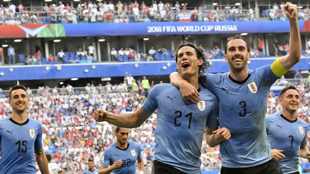 Uruguay's Edinson Cavani, centre, celebrates notching the third goal with teammate Diego Godin.